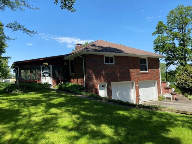 view of front of property with a front yard and a garage