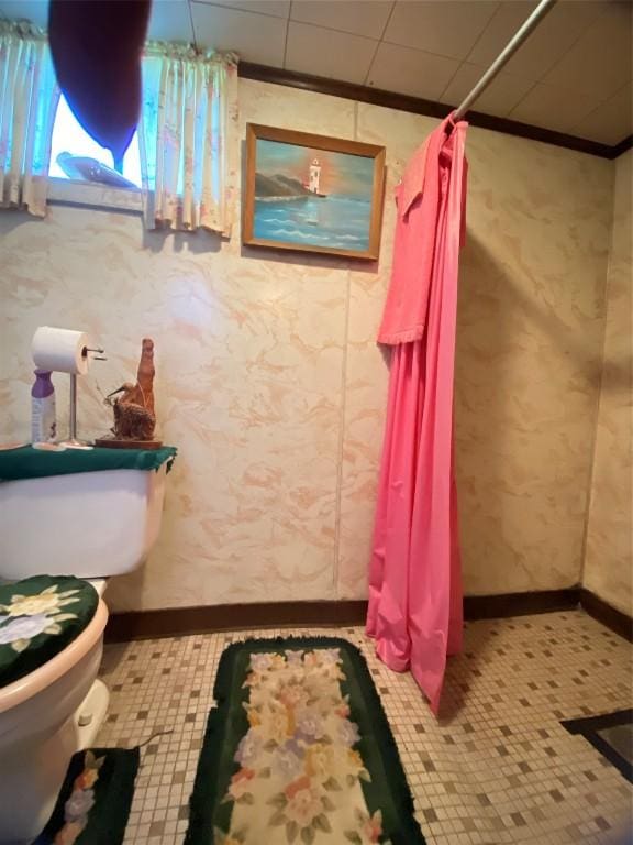 bathroom featuring walk in shower and toilet