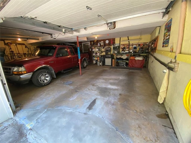 garage with a workshop area and a garage door opener