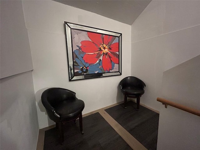 sitting room with lofted ceiling