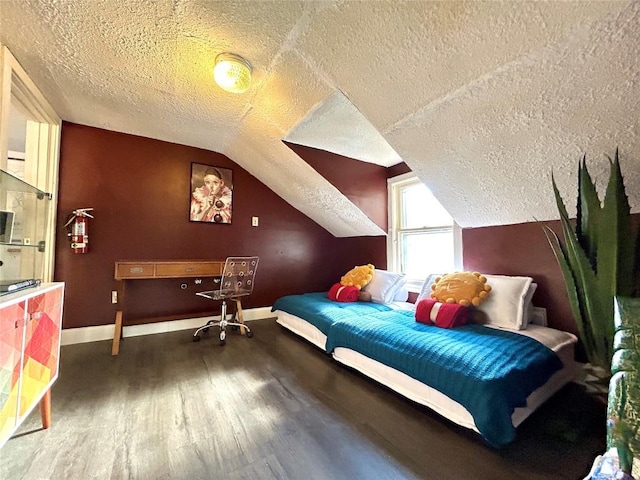 bedroom with hardwood / wood-style floors, lofted ceiling, and a textured ceiling