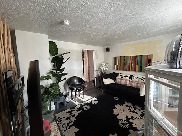 bedroom featuring hardwood / wood-style floors and a textured ceiling