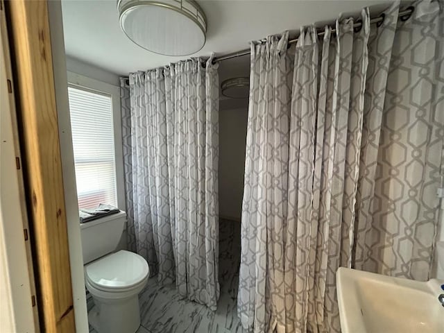 bathroom featuring tile patterned flooring and toilet