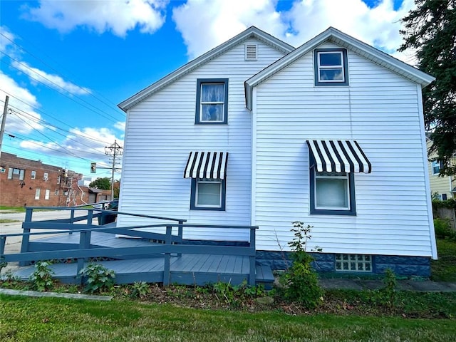 view of side of property featuring a wooden deck