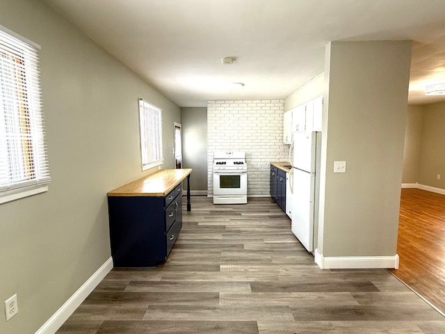 kitchen featuring white appliances, white cabinetry, dark hardwood / wood-style floors, blue cabinets, and wood counters