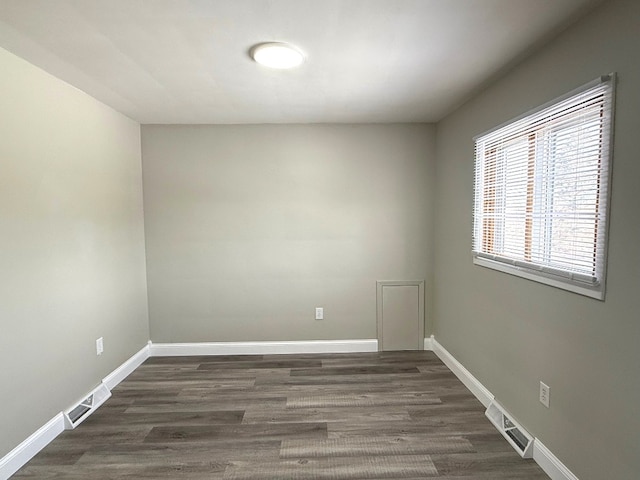 empty room featuring dark wood-type flooring