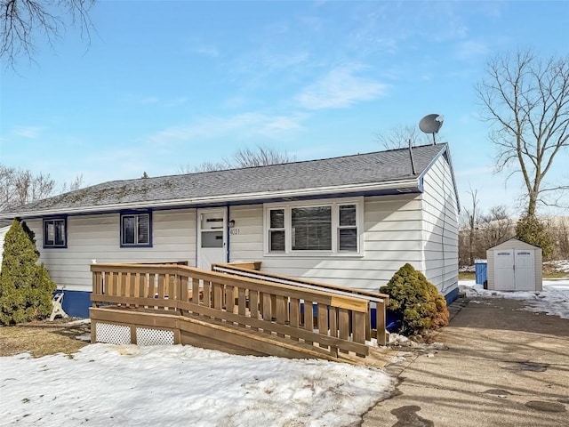 view of front of house with a deck and a shed