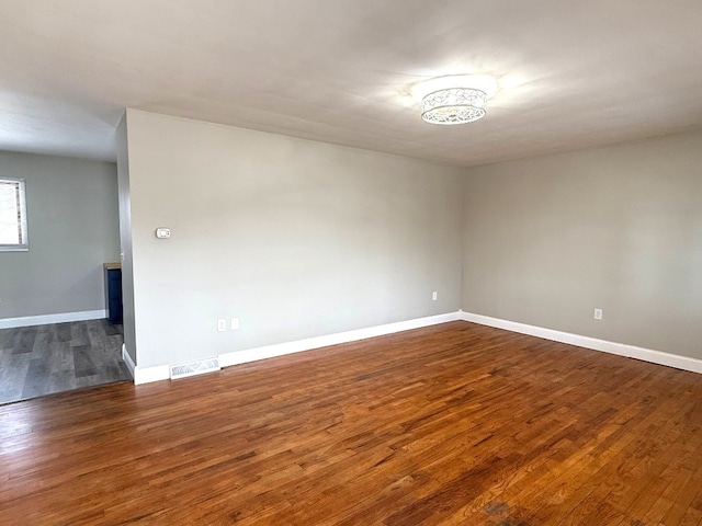 empty room featuring dark hardwood / wood-style flooring