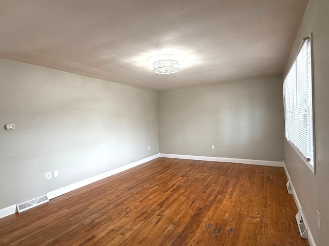 spare room featuring dark hardwood / wood-style floors