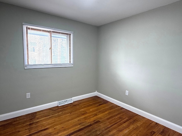 spare room with hardwood / wood-style flooring