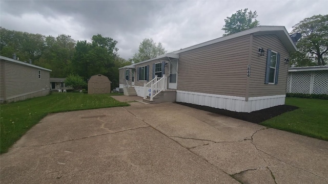 1644 Pinegrove Way, Erie, PA 16509 - view of side of property featuring a storage unit, an outbuilding, a lawn, and a patio area