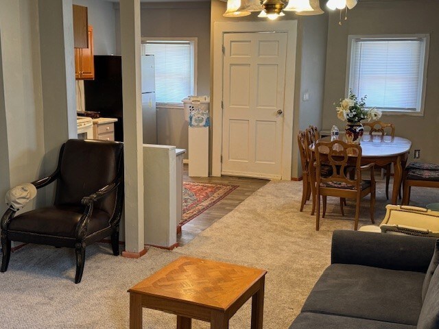 747 E 25th St, Erie, PA 16503 - living area with light carpet and a chandelier