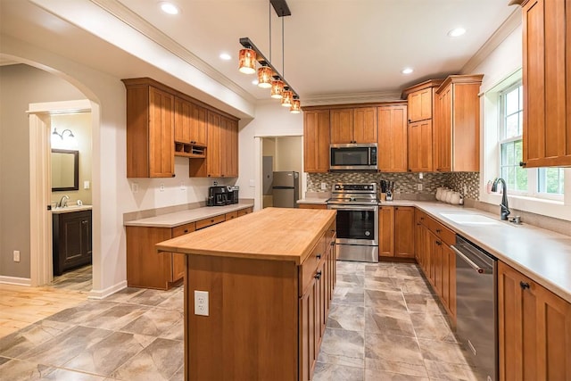 21720 Matthew Ln, Saegertown, PA 16433 - kitchen with appliances with stainless steel finishes, butcher block countertops, crown molding, a sink, and a center island