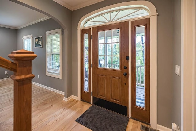 21720 Matthew Ln, Saegertown, PA 16433 - foyer with arched walkways, light wood-style floors, baseboards, and ornamental molding