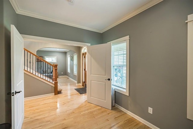 21720 Matthew Ln, Saegertown, PA 16433 - foyer entrance with arched walkways, ornamental molding, light wood-style flooring, baseboards, and stairway