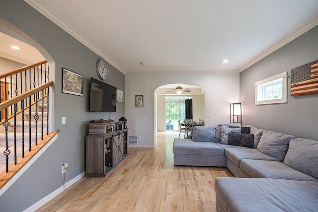 21720 Matthew Ln, Saegertown, PA 16433 - living room with arched walkways, light wood-style floors, ornamental molding, stairway, and baseboards