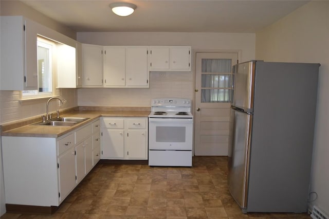 kitchen featuring sink, white electric range, stainless steel refrigerator, and white cabinets