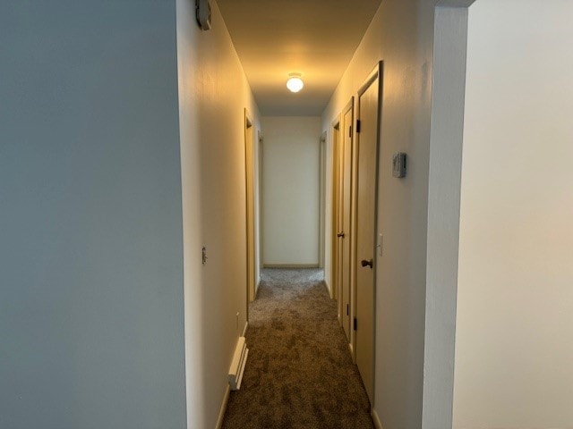 corridor with dark colored carpet