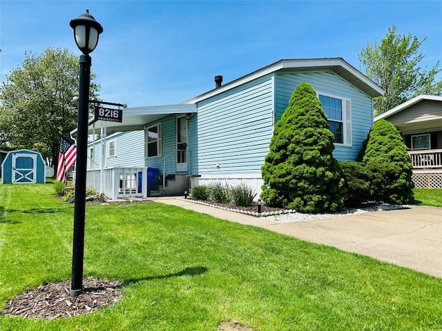 view of home's exterior featuring a yard, a storage unit, and an outdoor structure