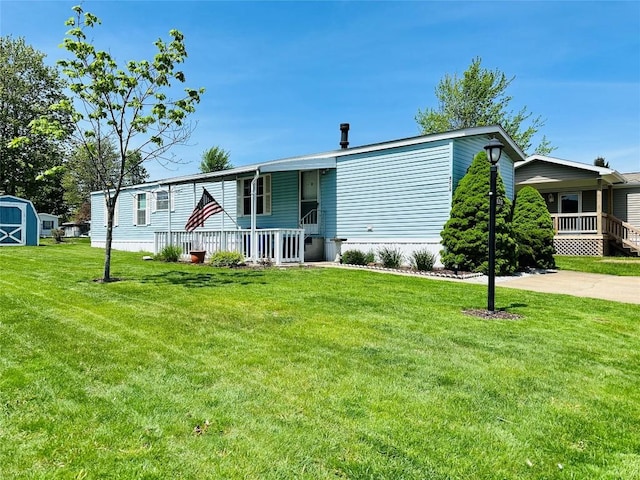 manufactured / mobile home with covered porch and a front lawn