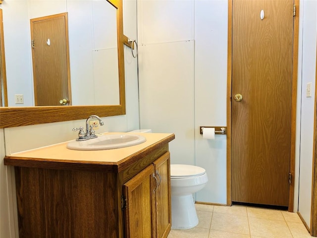 bathroom featuring vanity, toilet, and tile patterned floors