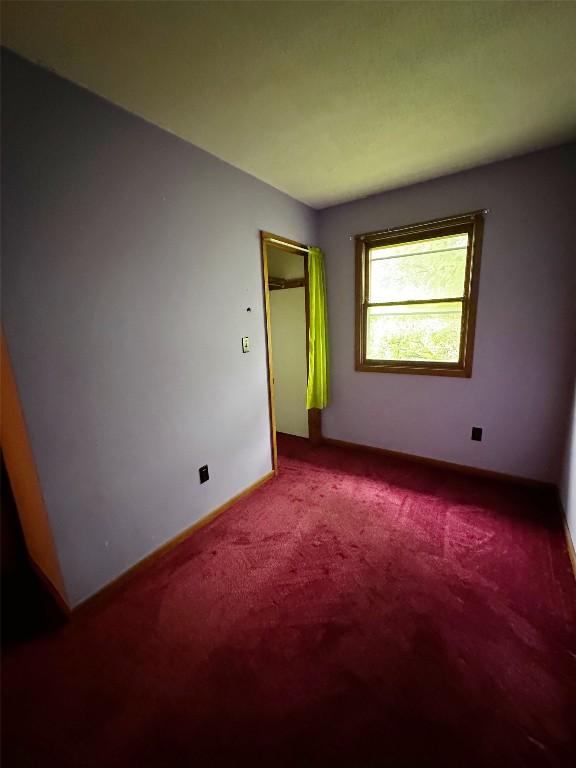 unfurnished bedroom with baseboards and carpet flooring