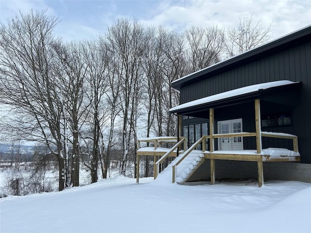 view of snow covered exterior featuring french doors