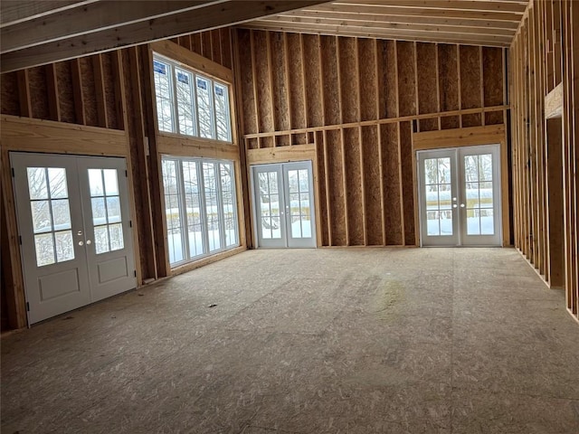 miscellaneous room with french doors and a towering ceiling