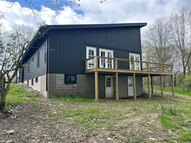 5241 Tarbell Rd, Edinboro, PA 16412 - back of property with a wooden deck, board and batten siding, and french doors
