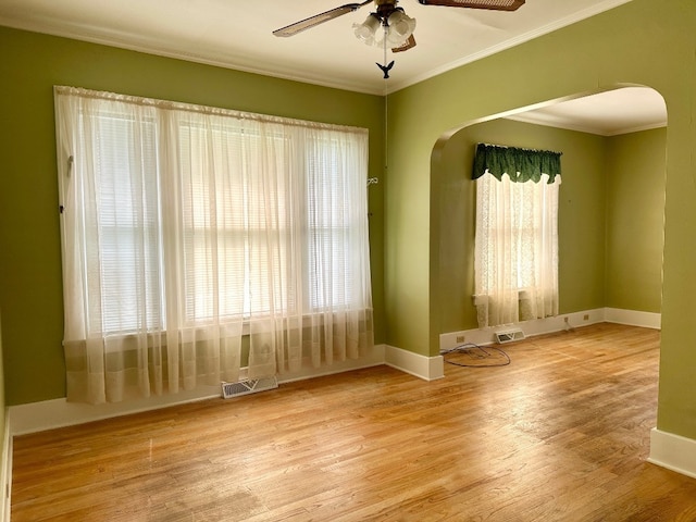 957 E 29th St, Erie, PA 16504 - spare room with arched walkways, ceiling fan, crown molding, and wood finished floors