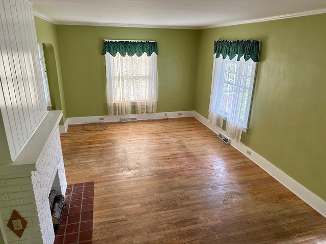 957 E 29th St, Erie, PA 16504 - spare room featuring ornamental molding, plenty of natural light, arched walkways, and wood finished floors