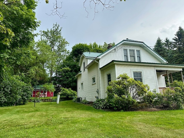 957 E 29th St, Erie, PA 16504 - view of property exterior with a yard, a chimney, and covered porch