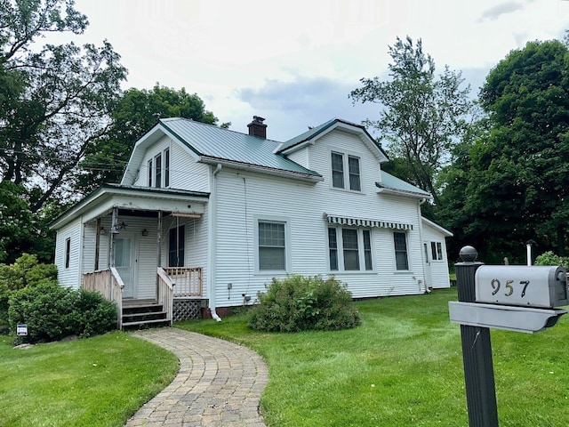 957 E 29th St, Erie, PA 16504 - view of front facade with a porch, a chimney, a front lawn, and a metal roof
