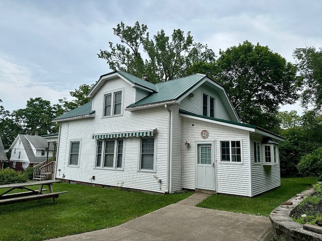 957 E 29th St, Erie, PA 16504 - rear view of property with a metal roof and a lawn