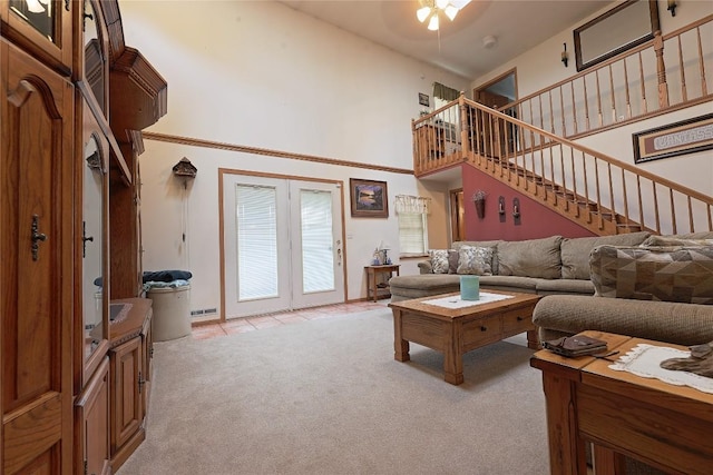 38753 Centerville Rd, Centerville, PA 16404 - living area featuring light colored carpet, a towering ceiling, stairway, a ceiling fan, and french doors