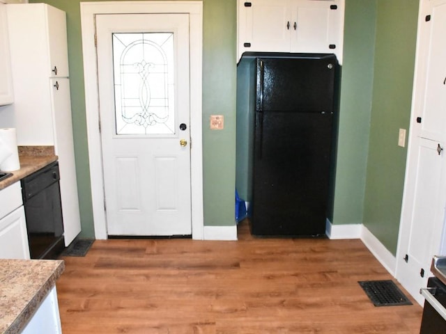 9954 Liberty Ext, Meadville, PA 16335 - kitchen featuring black appliances, white cabinetry, light wood-type flooring, and baseboards
