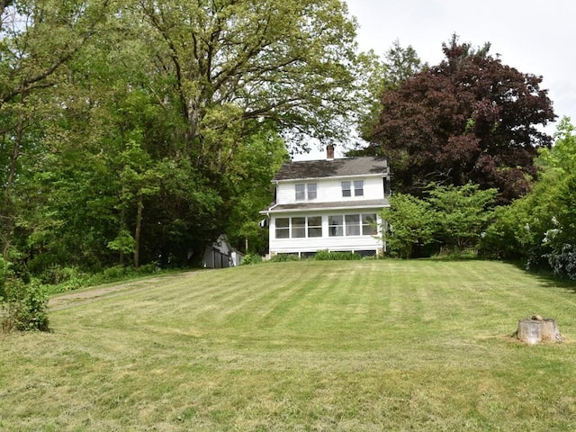 9954 Liberty Ext, Meadville, PA 16335 - back of property with a chimney, a yard, and a sunroom