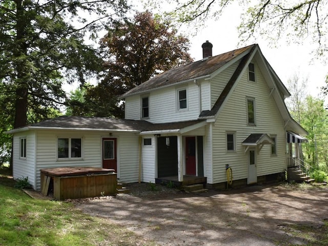 9954 Liberty Ext, Meadville, PA 16335 - rear view of property featuring a hot tub, a chimney, entry steps, and a shingled roof
