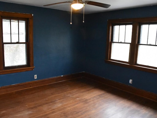spare room featuring baseboards, a ceiling fan, and wood finished floors