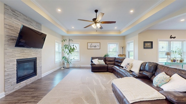 4758 Thoroughbred Loop, Erie, PA 16506 - living area featuring ceiling fan, healthy amount of natural light, ornamental molding, a fireplace, and wood finished floors