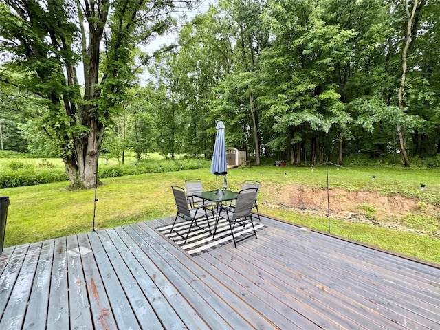 112 Willadell Rd, Pa, PA 16154 - wooden deck featuring outdoor dining space, a lawn, view of wooded area, and a shed