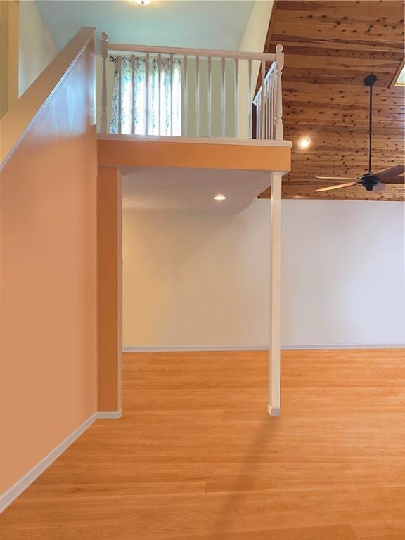 basement featuring ceiling fan and hardwood / wood-style flooring