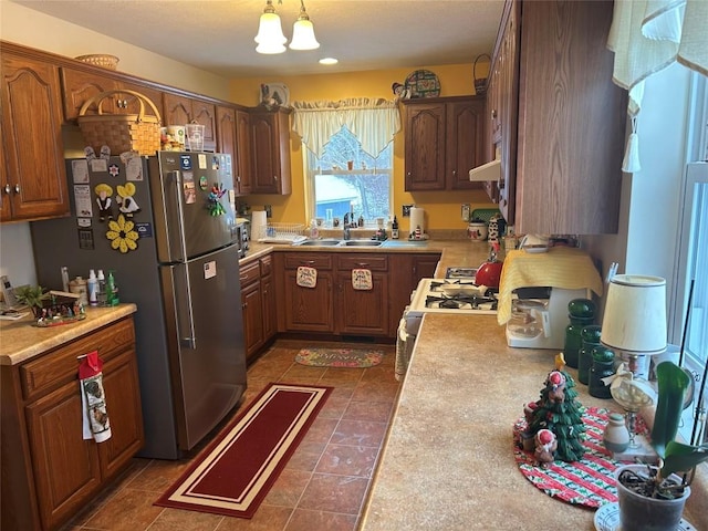 kitchen featuring custom exhaust hood, sink, white gas range, decorative light fixtures, and a chandelier