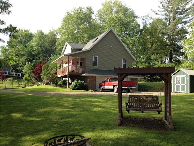 10492 Mohawk Rd, Conneaut Lake, PA 16316 - view of side of home featuring a shed, a lawn, stairway, view of wooded area, and a porch