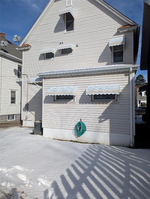 rear view of house featuring cooling unit