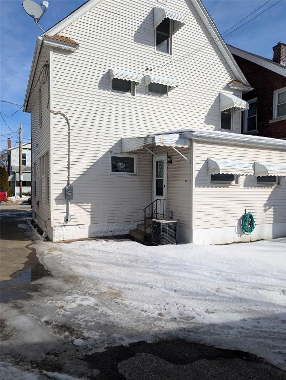 back of house with central air condition unit