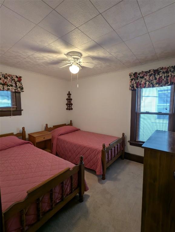 bedroom with light carpet and ceiling fan