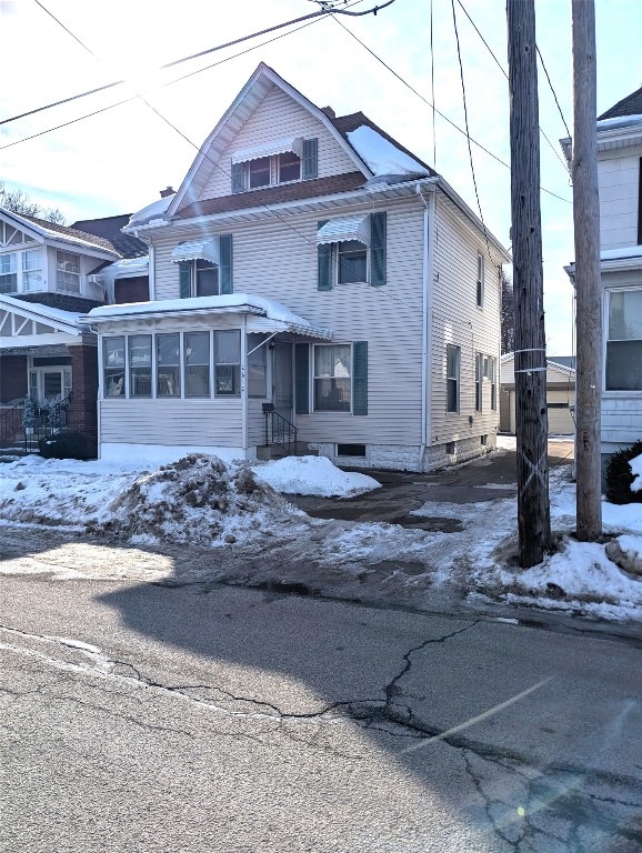 view of front of house featuring a sunroom