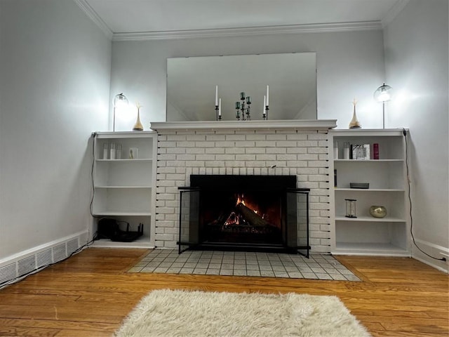 interior details with hardwood / wood-style flooring, ornamental molding, and a fireplace