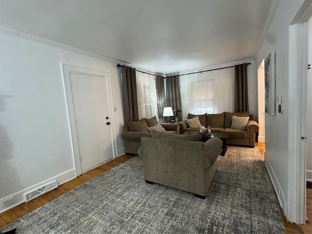 living room featuring dark wood-type flooring and ornamental molding